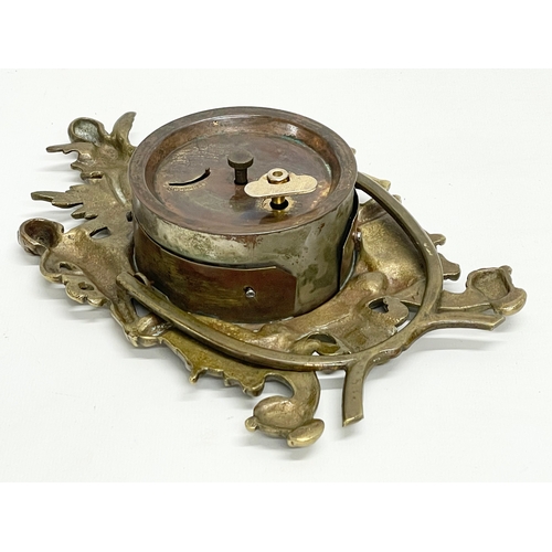 20 - An early 20th century ornate brass windup mantle clock with enamel and brass face and cherub decorat... 