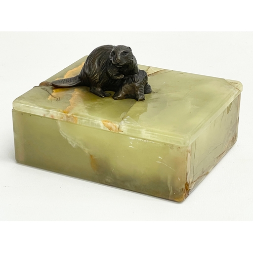 25 - An onyx cigarette box by Doris Linder for Asprey of London with a bronze beaver. 12x9.5x7.5cm