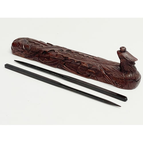 641 - Chinese chopsticks in carved wooden case. 24.5cm