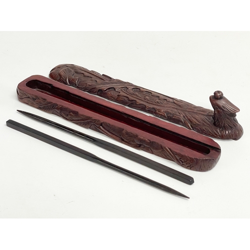 641 - Chinese chopsticks in carved wooden case. 24.5cm