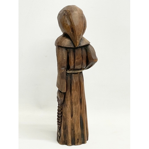 145 - An early 20th century Folk Art pine monk figure. 33cm