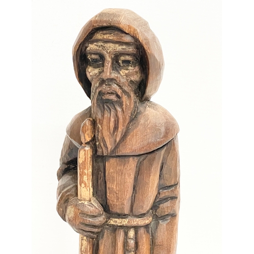 145 - An early 20th century Folk Art pine monk figure. 33cm