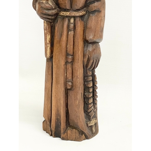 145 - An early 20th century Folk Art pine monk figure. 33cm