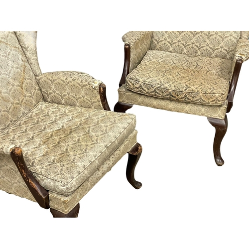 236 - A pair of vintage Parker Knoll wingback armchairs. Model number 918/19.