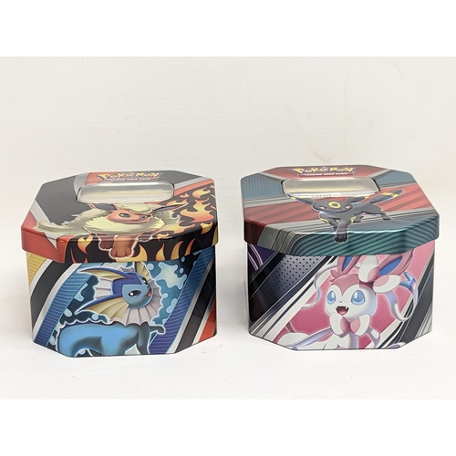 304 - A collection of Pokémon Trading Game Cards in Pokémon tins.