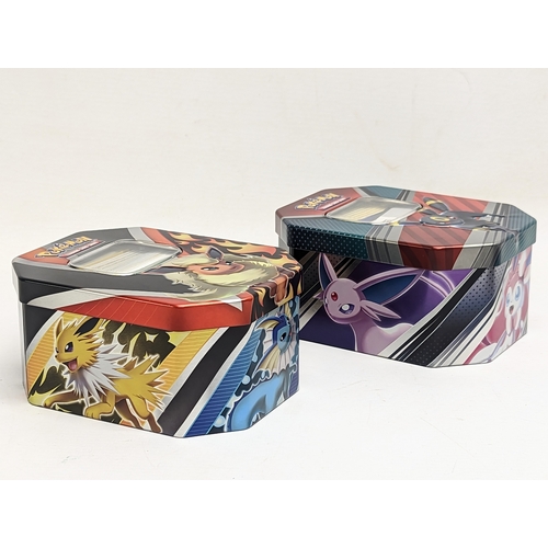 304 - A collection of Pokémon Trading Game Cards in Pokémon tins.