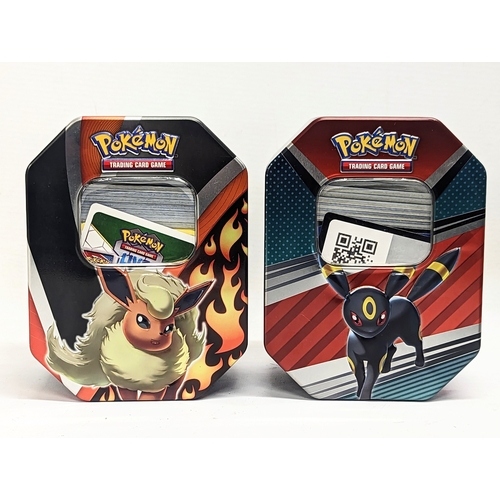 304 - A collection of Pokémon Trading Game Cards in Pokémon tins.