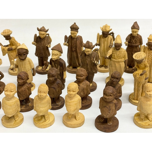 308 - A 34 Nigerian carved thorn wood chess pieces.