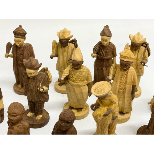 308 - A 34 Nigerian carved thorn wood chess pieces.