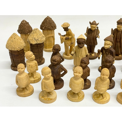 308 - A 34 Nigerian carved thorn wood chess pieces.