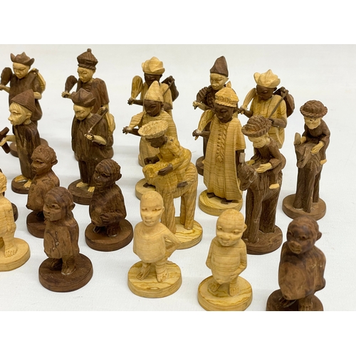 308 - A 34 Nigerian carved thorn wood chess pieces.