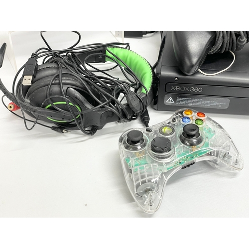 193 - An XBOX 360 with 2 controllers, speaker and headphones.