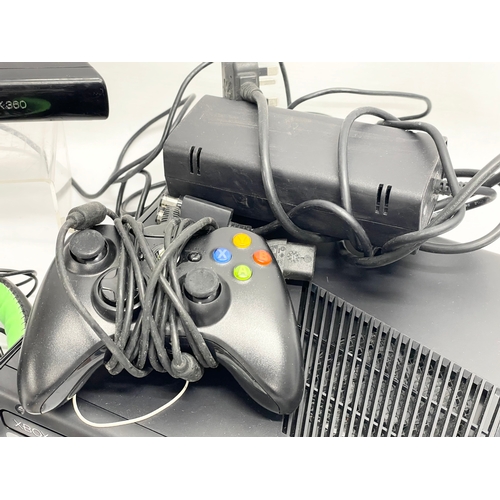 193 - An XBOX 360 with 2 controllers, speaker and headphones.