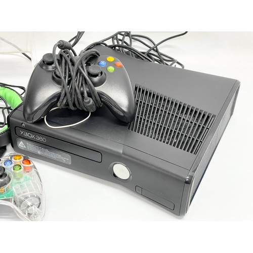 193 - An XBOX 360 with 2 controllers, speaker and headphones.