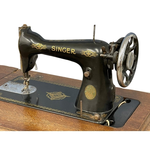 100 - A vintage oak Singer Sewing machine with accessories etc. 87x42x78cm