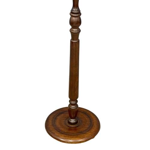 159 - A vintage mahogany standard lamp. 170cm