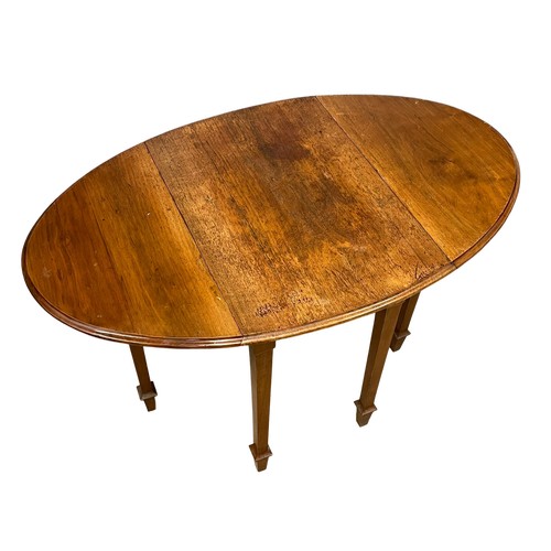 94 - A vintage Walnut drop leaf table. Open 115x71x76.5cm. Closed 49x71x76.5cm