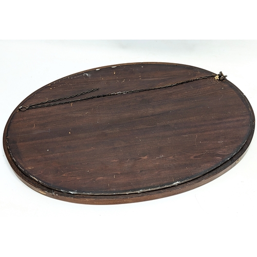 218A - An Edwardian inlaid mahogany bevelled mirror. 71x50.5cm