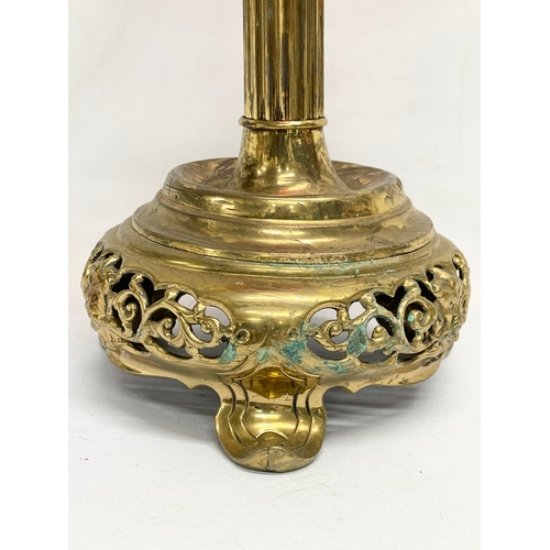 67 - A Victorian electrified oil lamp with Ruby Glass bowl and brass base. 40cm.