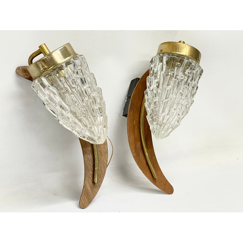 68 - A pair of Mid Century teak and brass wall lights with glass shades. 29cm