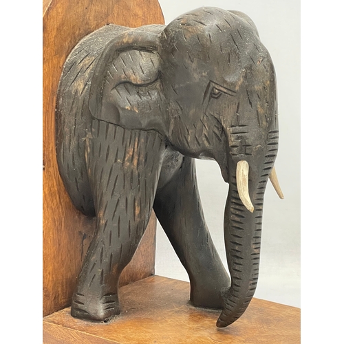 603 - A pair of carved wooden elephant bookends. 19x27cm