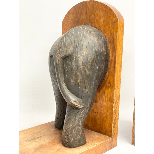 603 - A pair of carved wooden elephant bookends. 19x27cm