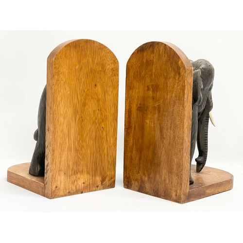 603 - A pair of carved wooden elephant bookends. 19x27cm