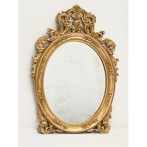 77 - An ornate framed mirror. 37.5x54cm