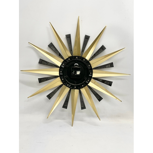 1 - A Mid Century sunburst clock by Metamic. 60cm