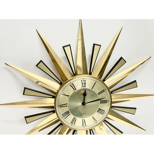 1 - A Mid Century sunburst clock by Metamic. 60cm