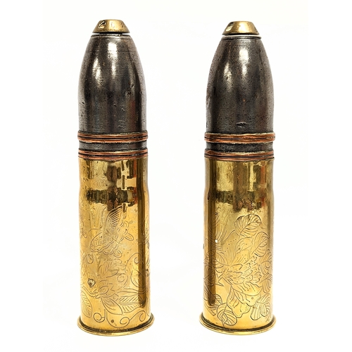 23 - A pair of early 20th century brass and copper heavy gun shells, deactivated. 17cm