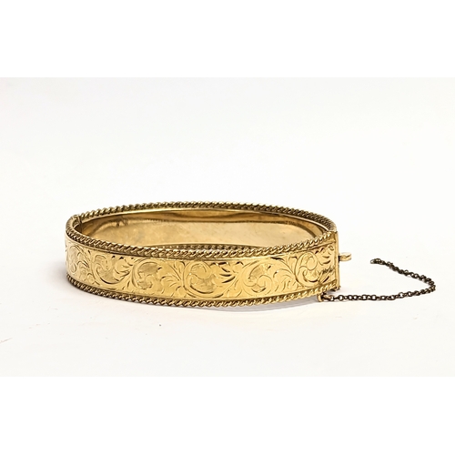 722 - A rolled gold bangle.