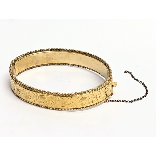 722 - A rolled gold bangle.