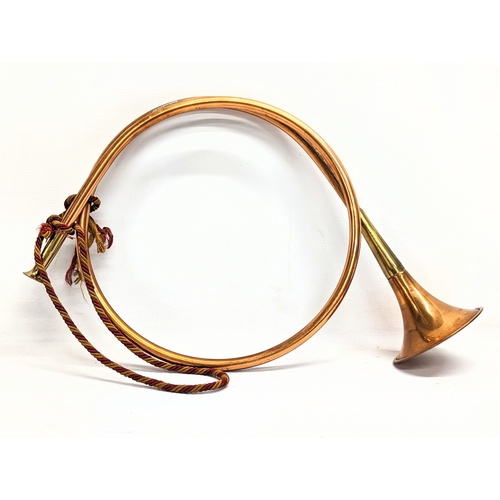 196 - An early 20th century brass bugle with early 20th century copper and brass hunting horn.