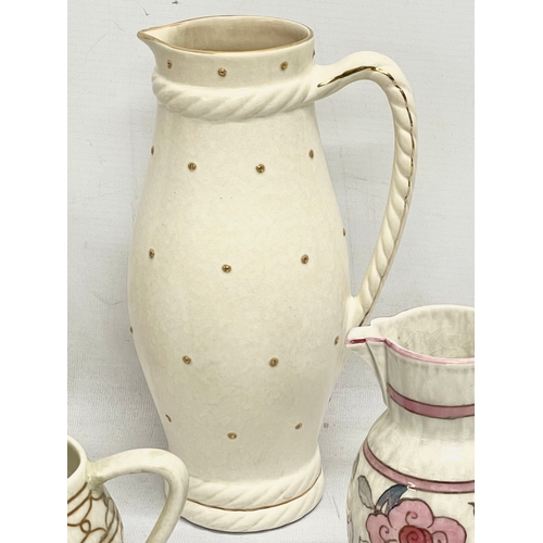 663 - 4 Charlotte Rhead pottery jugs, designed for Crown Ducal. Largest 23.5cm