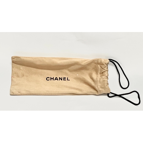 724 - A pair of ladies Chanel sunglasses with case and cover.