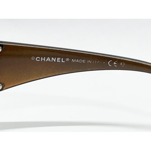 724 - A pair of ladies Chanel sunglasses with case and cover.