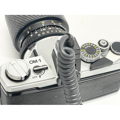 280 - An Olympus OM-1 camera with a Tokina SD 70-210mm lens.