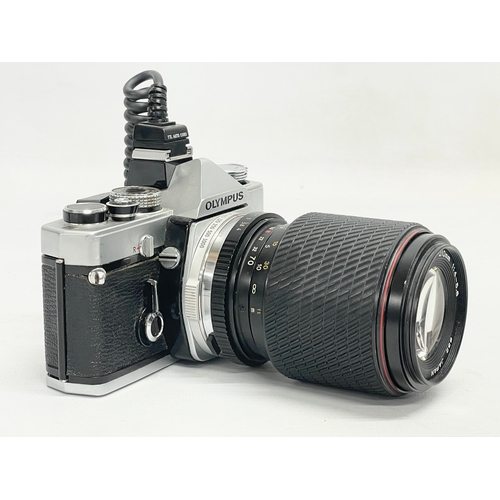 280 - An Olympus OM-1 camera with a Tokina SD 70-210mm lens.