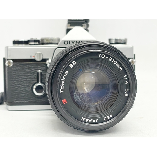 280 - An Olympus OM-1 camera with a Tokina SD 70-210mm lens.