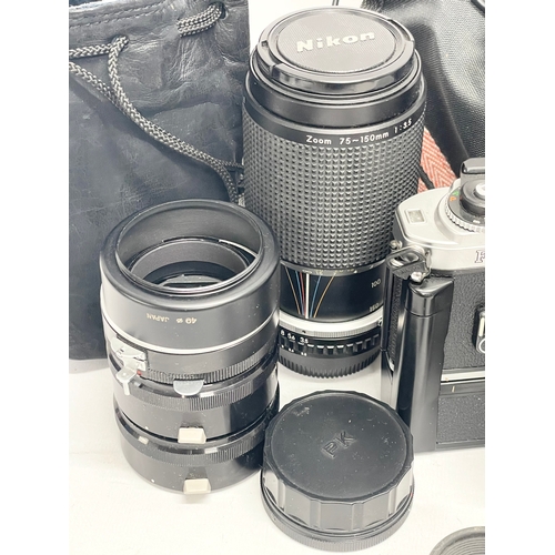 296 - A Nikon FG camera with Nikon bag and accessories. Including a Nikon Series E lens 75-150mm 1:3.5. Ni... 