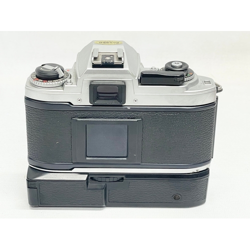 296 - A Nikon FG camera with Nikon bag and accessories. Including a Nikon Series E lens 75-150mm 1:3.5. Ni... 