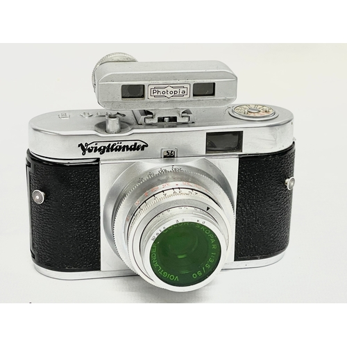 411 - 3 Voigtlander cameras. A Voigtlander Vitessa camera, a Voigtlamder Vito B camera and a Voigtlander V... 