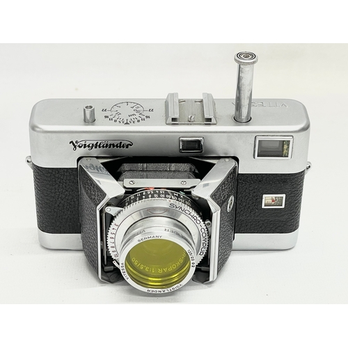 411 - 3 Voigtlander cameras. A Voigtlander Vitessa camera, a Voigtlamder Vito B camera and a Voigtlander V... 