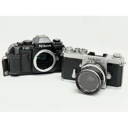 415 - A Nikon F camera and a Nikon F-301 camera.