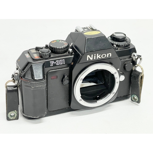 415 - A Nikon F camera and a Nikon F-301 camera.