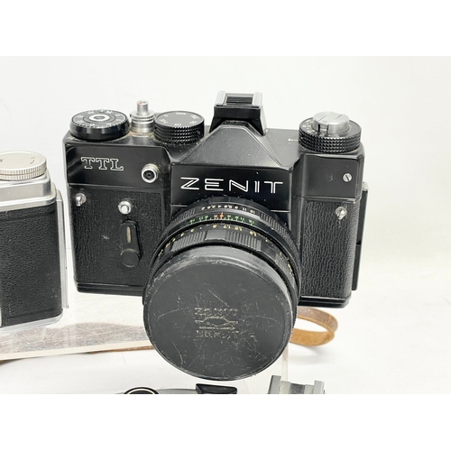 417 - 4 vintage cameras. A Topcon Unirex camera. A Topcon Wink S Mirror camera. A Zenit TTL camera and an ... 