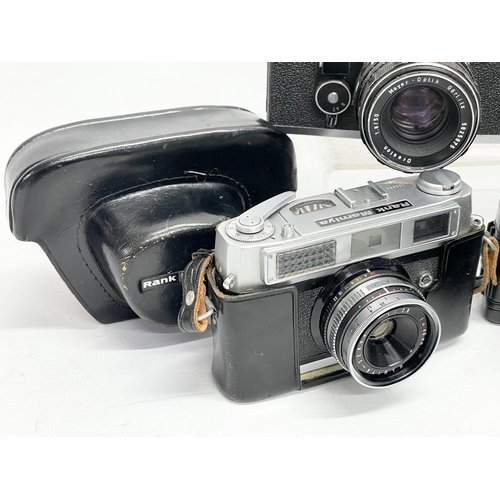 418 - 4 vintage cameras. A Praktica BC1 Electronic camera. A Rank Mamiya camera. An Exakta RTL 1000 camera... 