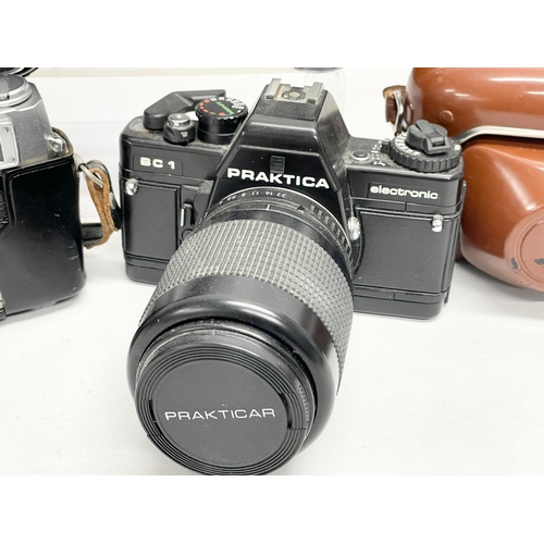 418 - 4 vintage cameras. A Praktica BC1 Electronic camera. A Rank Mamiya camera. An Exakta RTL 1000 camera... 