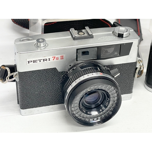 419 - 4 vintage cameras. A Zeiss Ikon Contessa camera. A lloca Quick-B camera. A FED 3 camera. A Petri 7S ... 